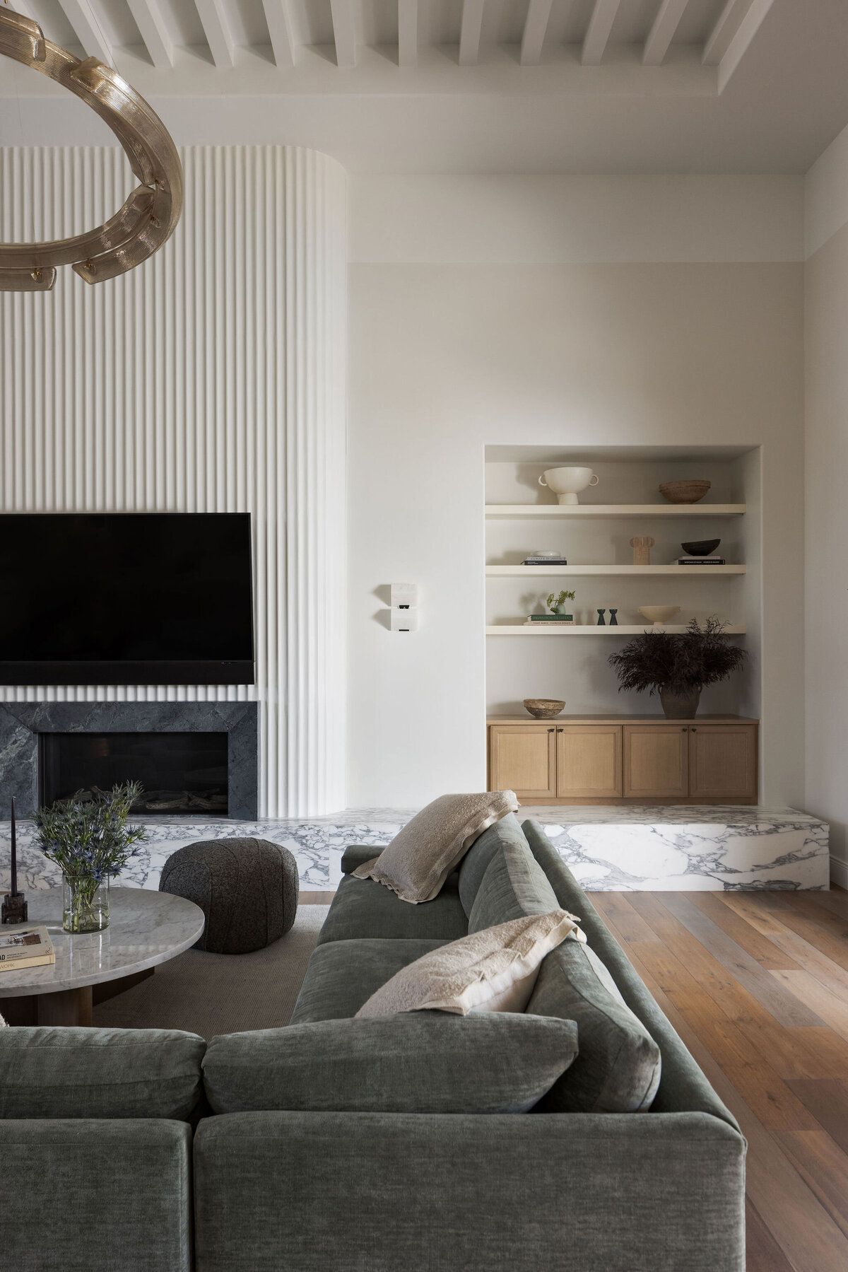Living room with a fluted fireplace designed by Haven Studios